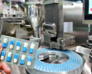 hand-holding-blue-capsule-pack-medicine-pill-productionline