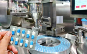 hand-holding-blue-capsule-pack-medicine-pill-productionline